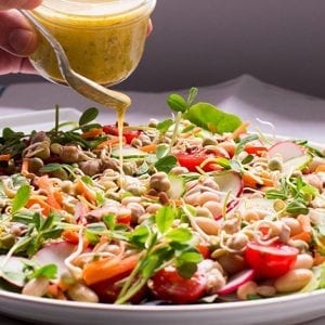 Cannellini bean and vegetable salad with Eatmore mixed bean sprouts, pea shoots, cherry tomatoes, radishes, and honey-Dijon dressing.