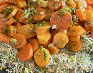 Moroccan carrot salad served over Eatmore Deli Blend with green onions, cilantro, and a lemon garlic dressing.