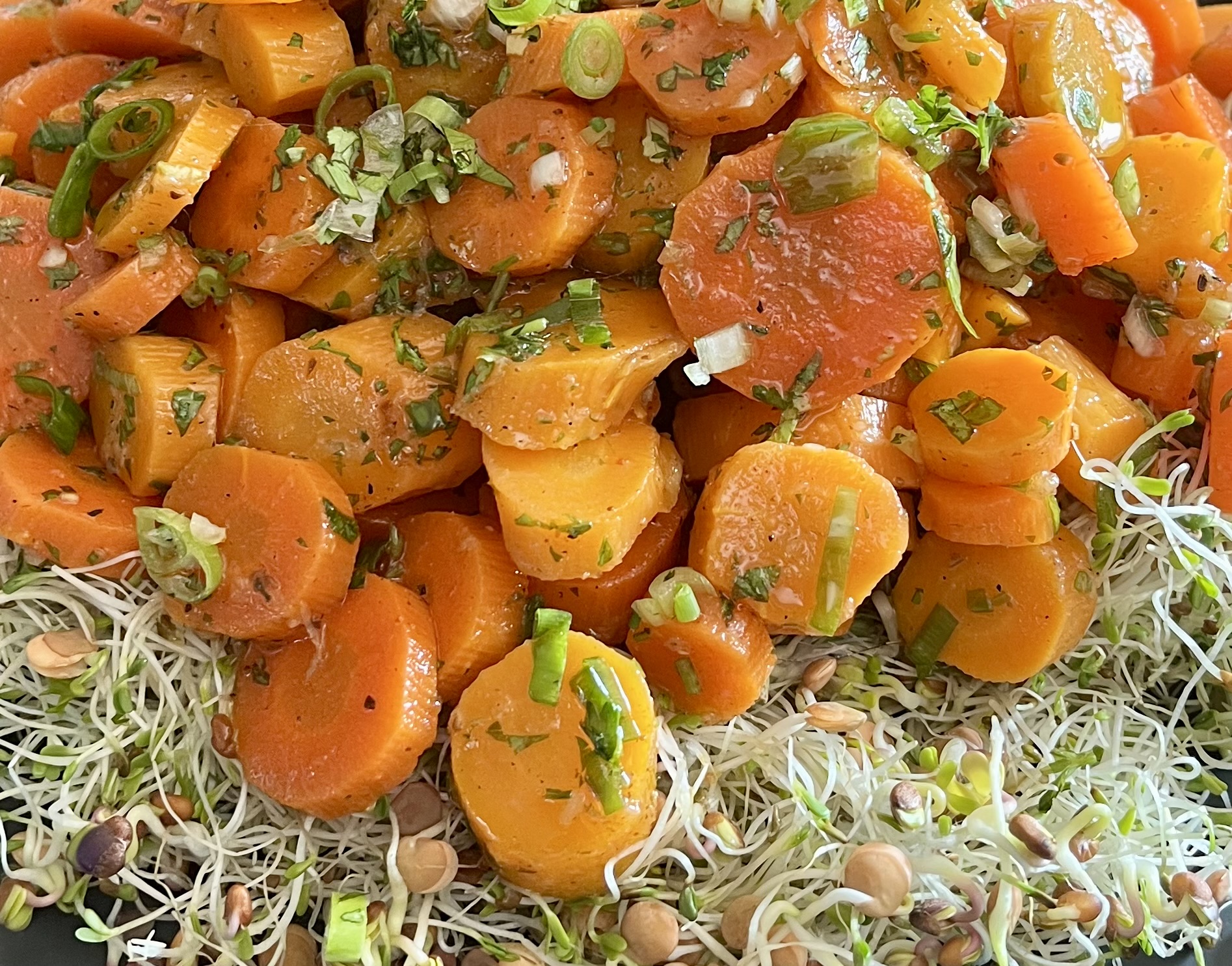 Moroccan carrot salad served over Eatmore Deli Blend with green onions, cilantro, and a lemon garlic dressing.