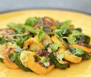 Marinated green and yellow zucchini with basil and Eatmore Microgreens.