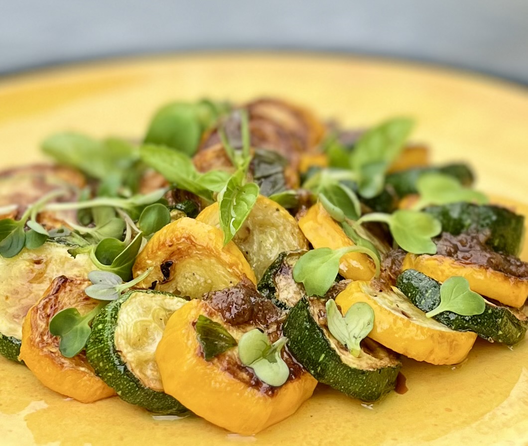 Marinated green and yellow zucchini with basil and Eatmore Microgreens.